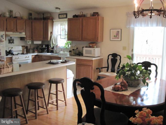 9269 Mountjoy Road Marshall, VA 20115 - Photo 10 of 14 a kitchen with stainless steel appliances granite countertop a table chairs a stove a sink and dishwasher