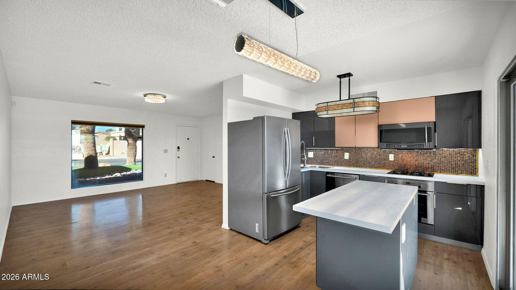 15625 North 20th Street Phoenix, AZ 85022 - Photo 6 of 25 a kitchen with kitchen island a sink appliances and cabinets