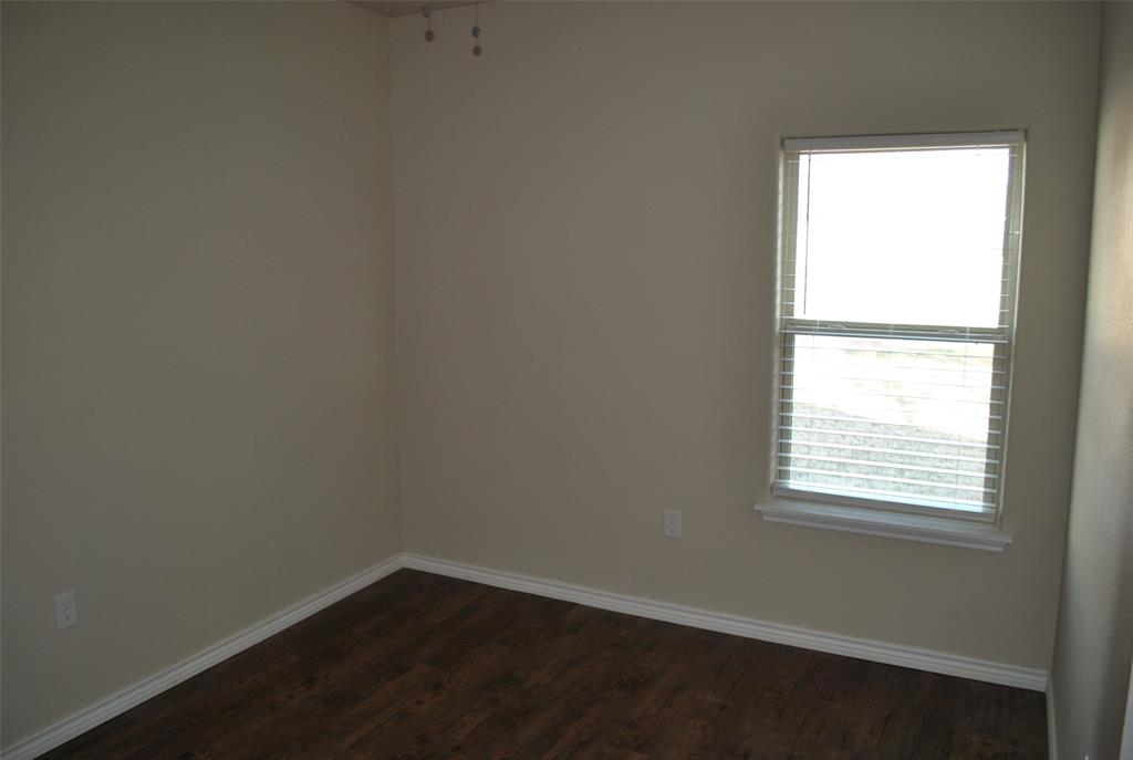 412 Dewitt Street Collinsville, TX 76233 - Photo 6 of 17 an empty room with a window
