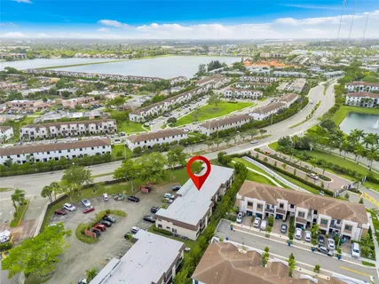 an aerial view of residential building and lake