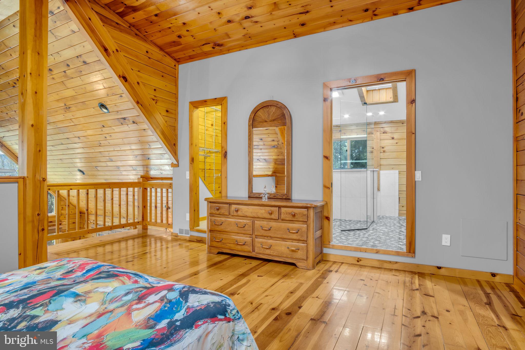 254 Stuart Road Carlisle, PA 17015 - Photo 33 of 102 a bedroom with a bed and wooden floor