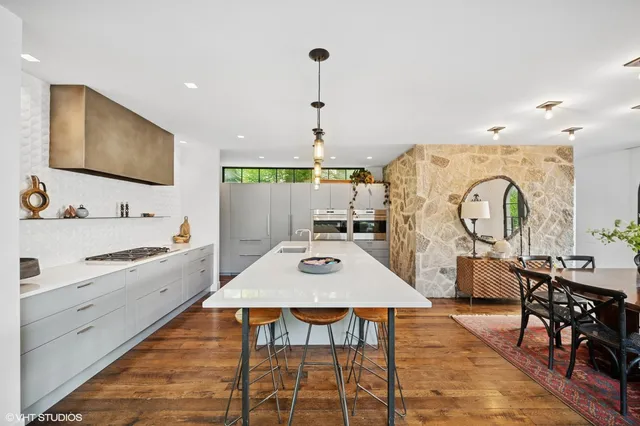 a large kitchen with a table and chairs