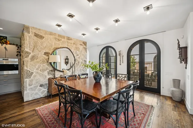 a dining room with furniture a rug and wooden floor
