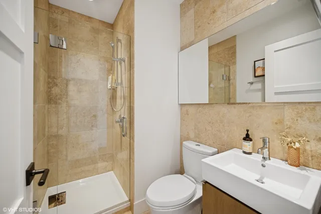 a bathroom with a sink toilet and shower