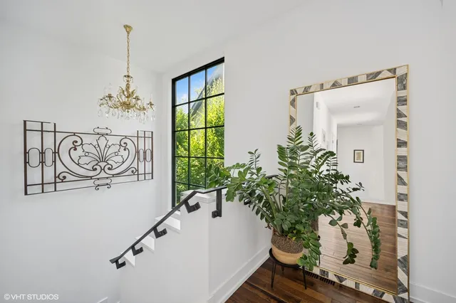 a view of entryway with paintings on the wall