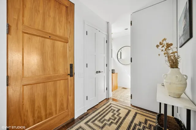 a view of a room that has a bed and wooden floor