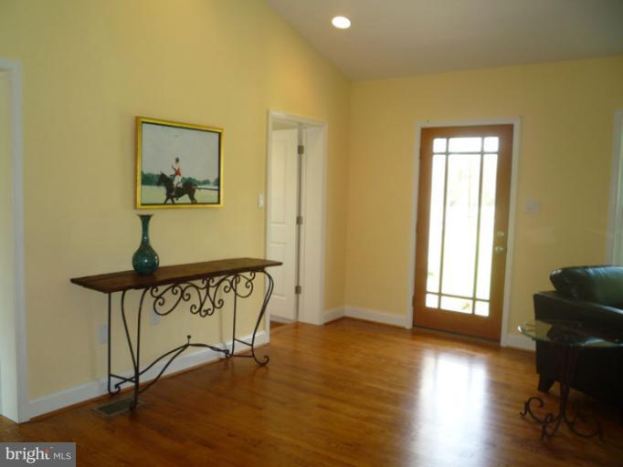 20300 Whites Ferry Road Poolesville, MD 20837 - Photo 1 of 30 a view of a hallway with wooden floor and a potted plant