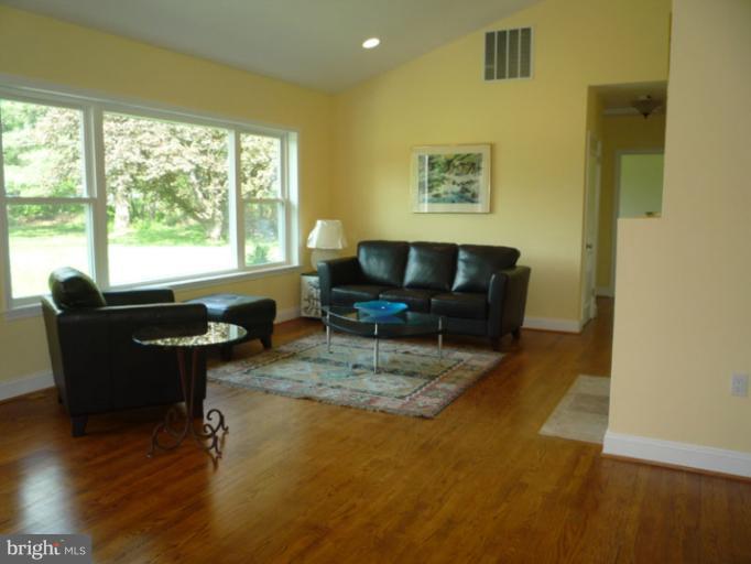 20300 Whites Ferry Road Poolesville, MD 20837 - Photo 2 of 30 a living room with furniture and a large window