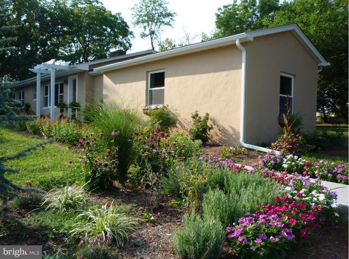 20300 Whites Ferry Road Poolesville, MD 20837 - Photo 22 of 30 a house with a lot of flower plants in front of house