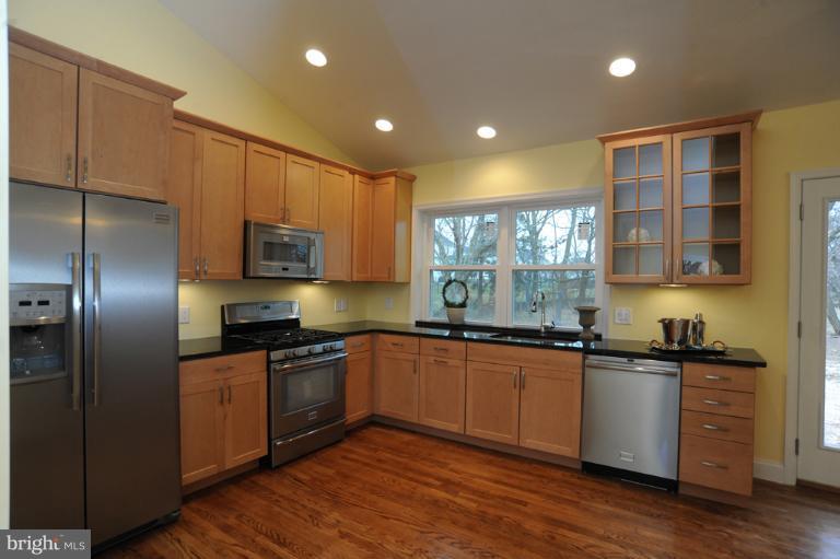 20300 Whites Ferry Road Poolesville, MD 20837 - Photo 29 of 30 a kitchen with stainless steel appliances granite countertop a sink a stove and refrigerator