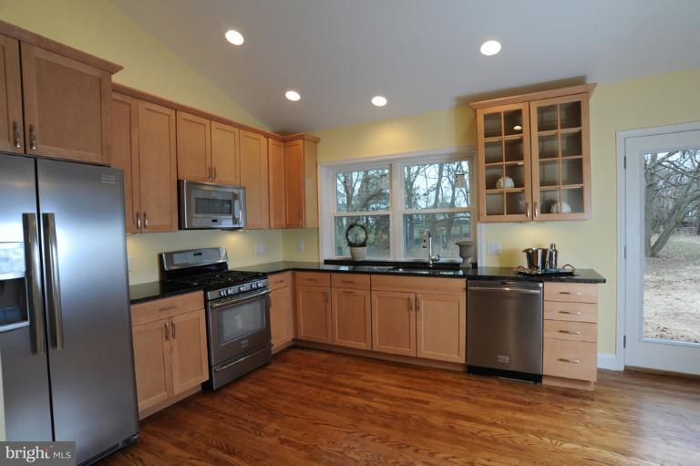 20300 Whites Ferry Road Poolesville, MD 20837 - Photo 5 of 30 a kitchen with stainless steel appliances granite countertop a stove a sink and a refrigerator