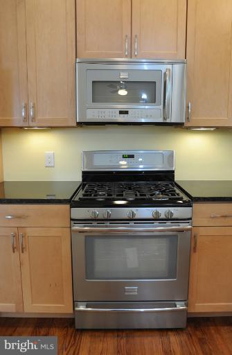 20300 Whites Ferry Road Poolesville, MD 20837 - Photo 9 of 30 a stove top oven sitting inside of a kitchen