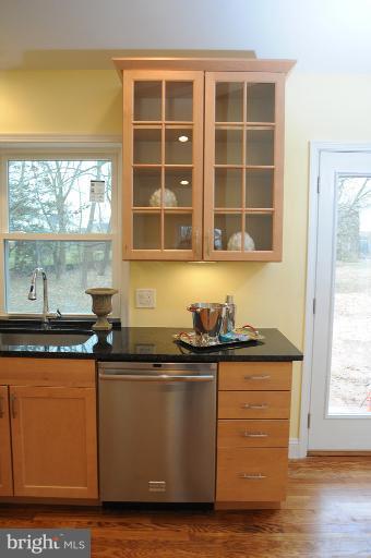 20300 Whites Ferry Road Poolesville, MD 20837 - Photo 10 of 30 a kitchen with granite countertop a sink window and cabinets