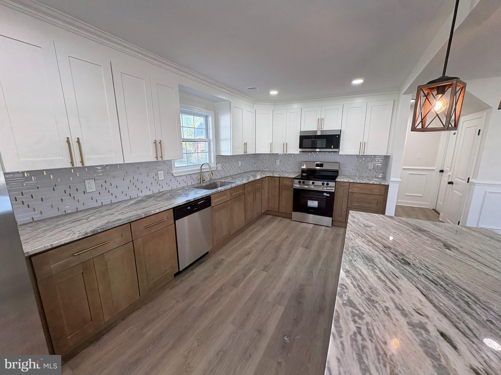50 Micahill Road Levittown, PA 19056 - Photo 13 of 45 a large kitchen with stainless steel appliances granite countertop a stove a sink and a refrigerator