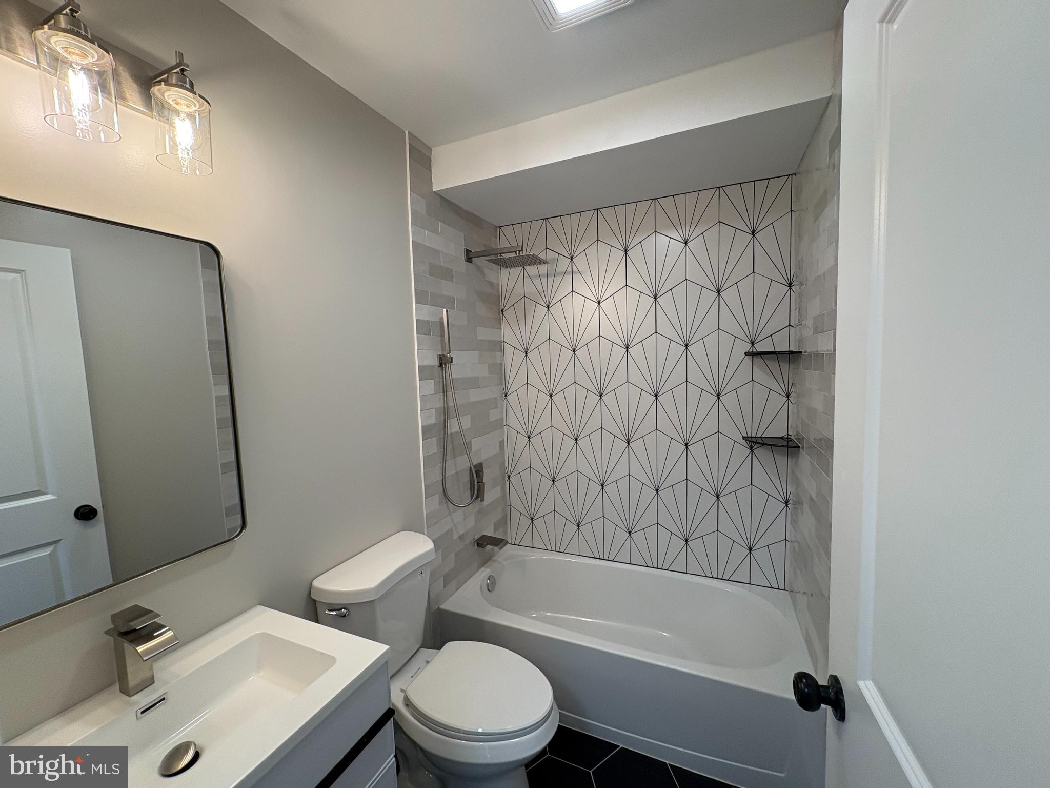 50 Micahill Road Levittown, PA 19056 - Photo 15 of 45 a bathroom with a bathtub shower sink vanity and toilet