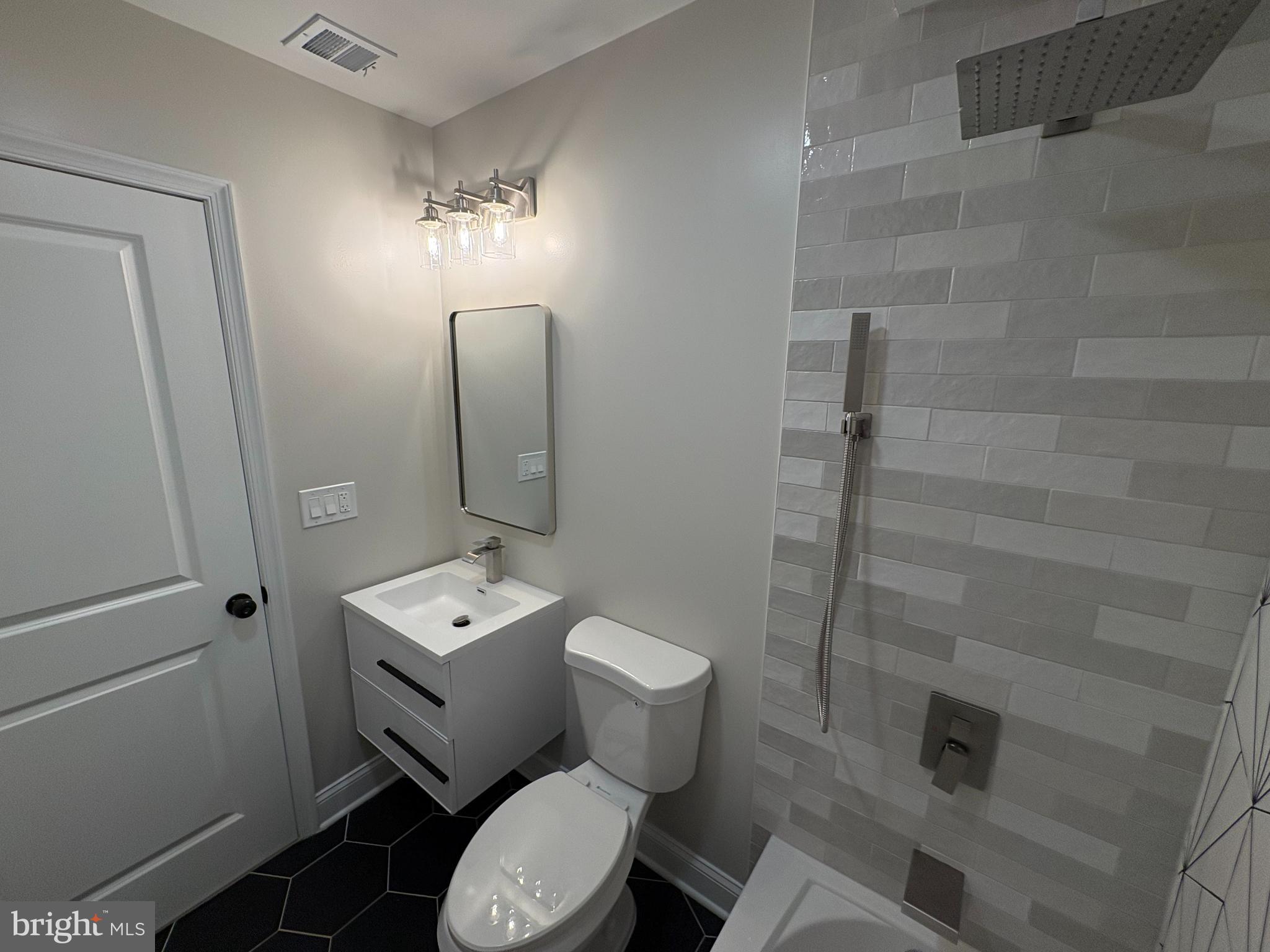 50 Micahill Road Levittown, PA 19056 - Photo 17 of 45 a bathroom with a toilet a sink and mirror