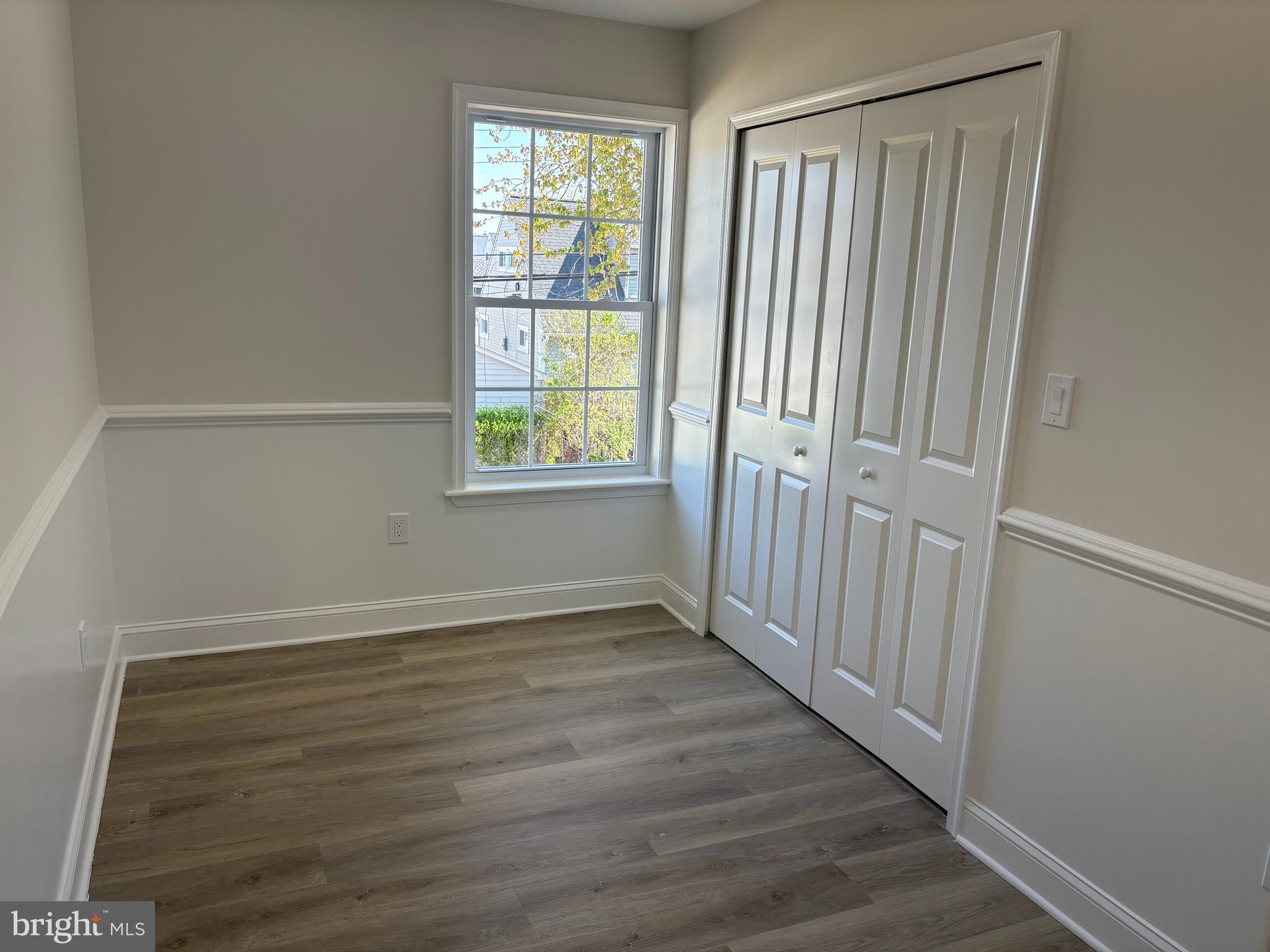 50 Micahill Road Levittown, PA 19056 - Photo 26 of 45 an empty room with wooden floor and windows