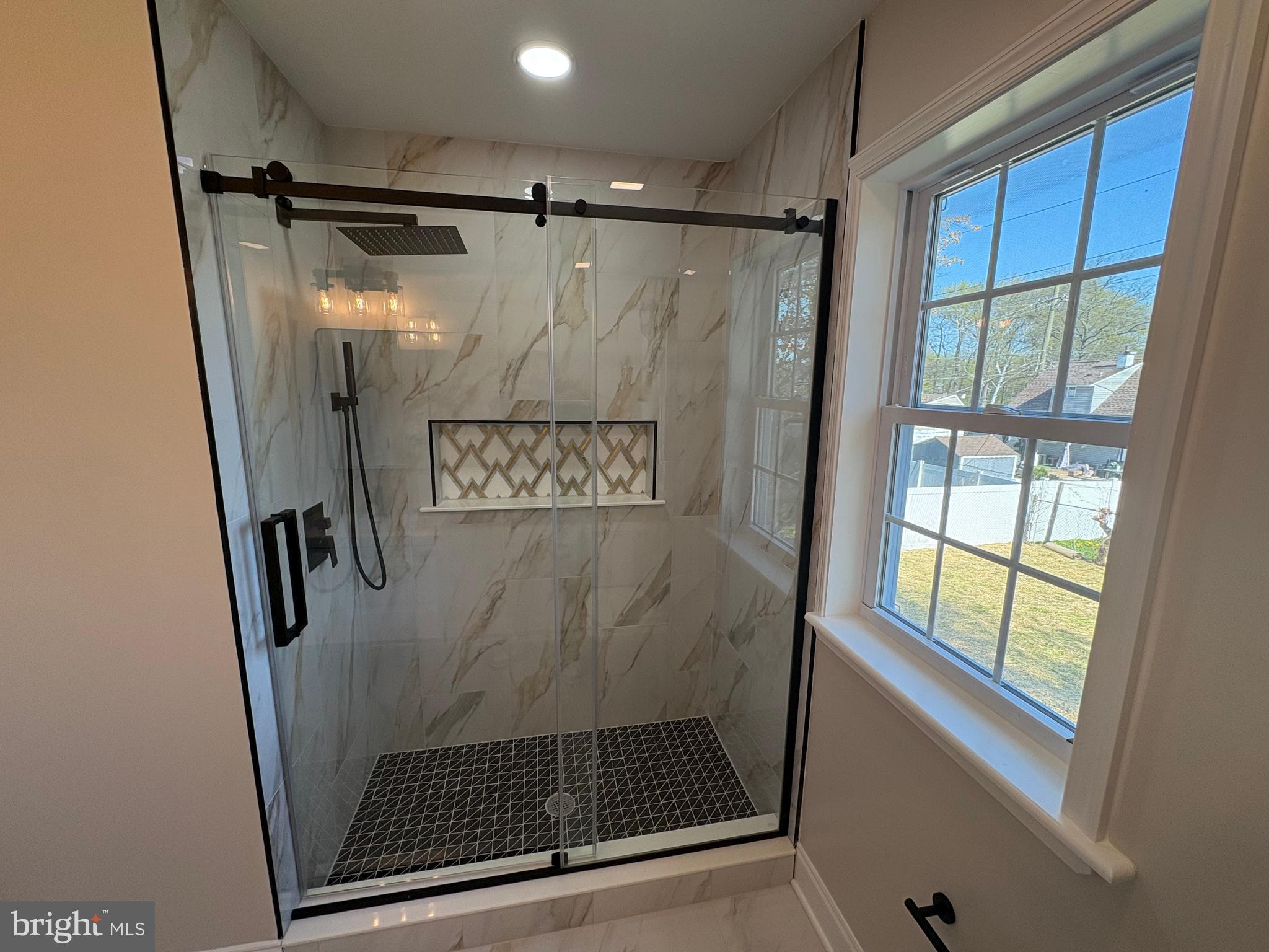 50 Micahill Road Levittown, PA 19056 - Photo 28 of 45 a bathroom with a glass shower door