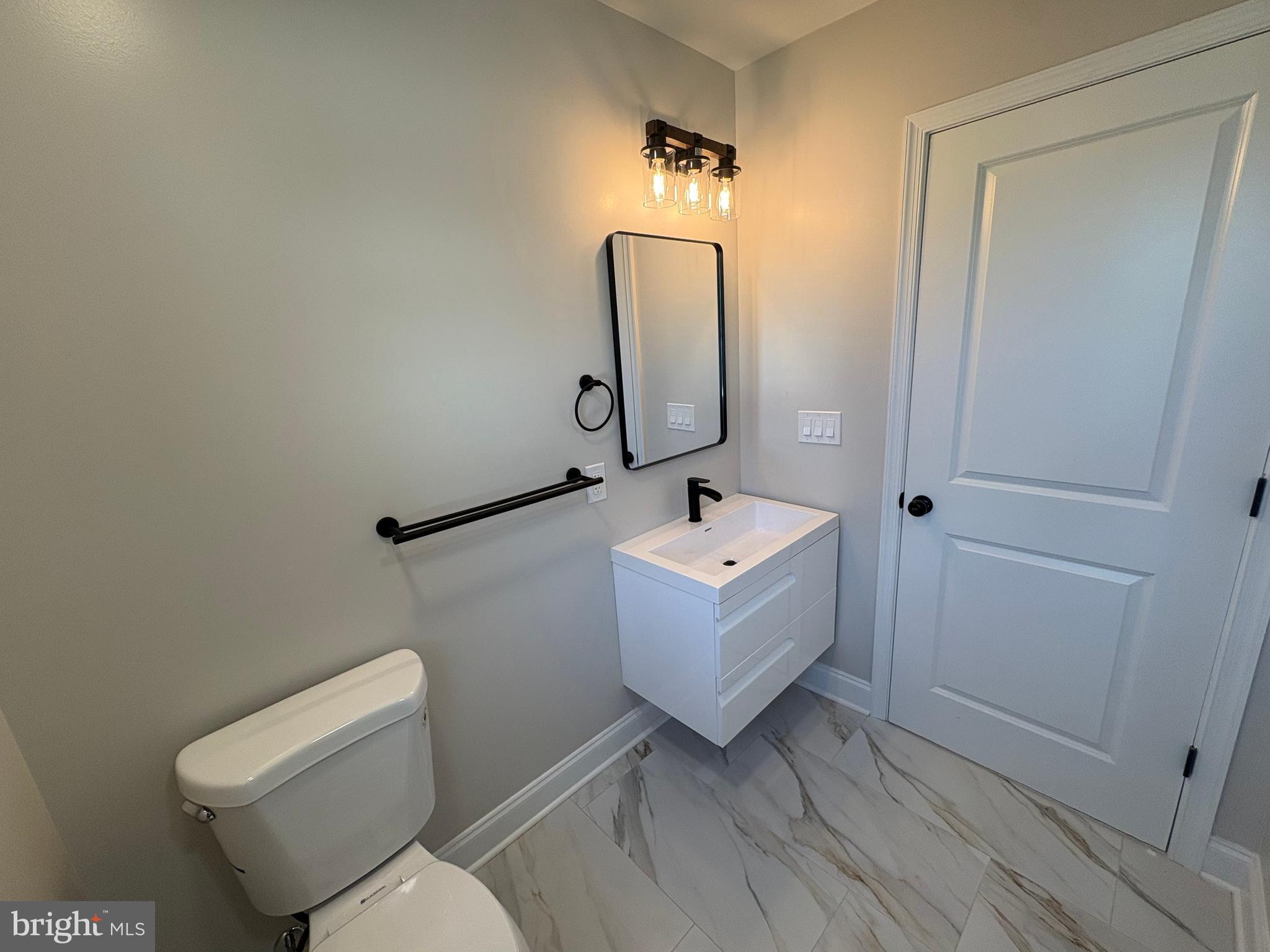 50 Micahill Road Levittown, PA 19056 - Photo 30 of 45 a bathroom with a toilet sink and mirror