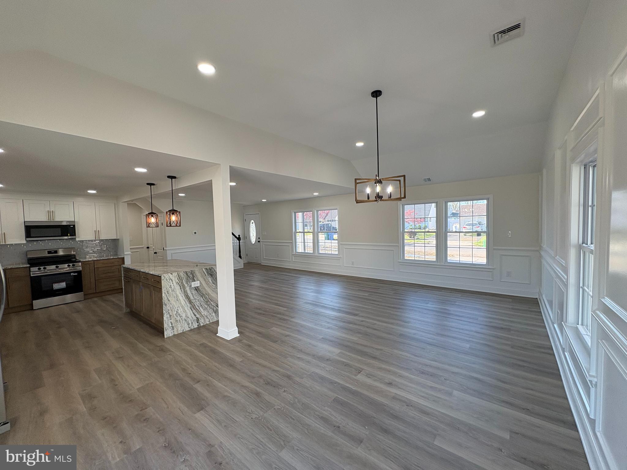 50 Micahill Road Levittown, PA 19056 - Photo 10 of 45 a view of an empty room and kitchen with furniture wooden floor kitchen view