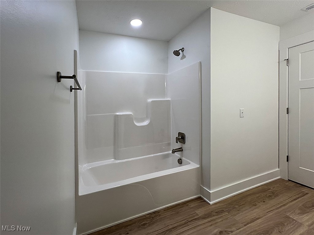 3641 Menlo Road Cleveland, OH 44120 - Photo 13 of 26 Bathroom featuring washtub / shower combination, quartz counters and wood finished floors