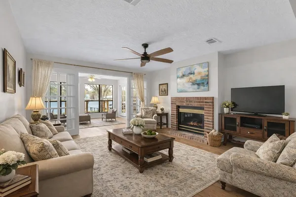 a living room with furniture a fireplace and a flat screen tv