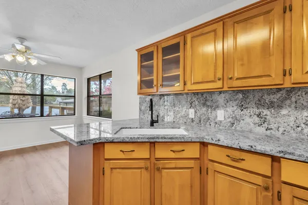 a kitchen with granite countertop cabinets and window