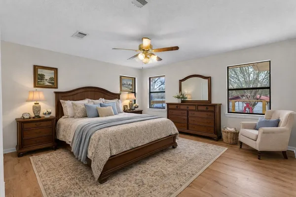 a spacious bedroom with a bed and a couch