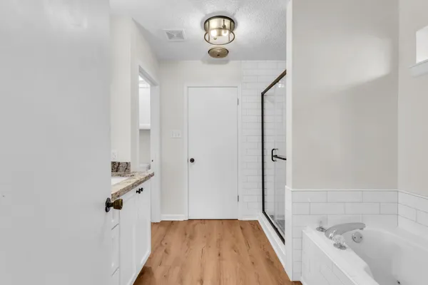 a bathroom with a bathtub and a shower