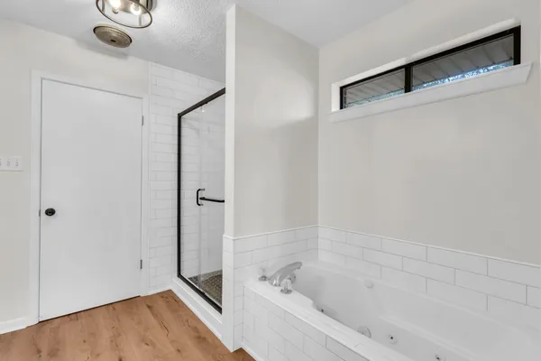 a bathroom with a bathtub and a shower