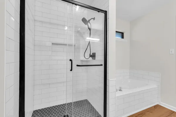 a bathroom with a glass shower door