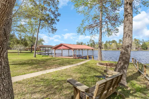 a view of a house with a yard and sitting area