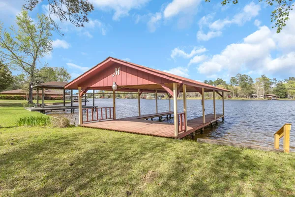 a view of a house with a yard table and chairs
