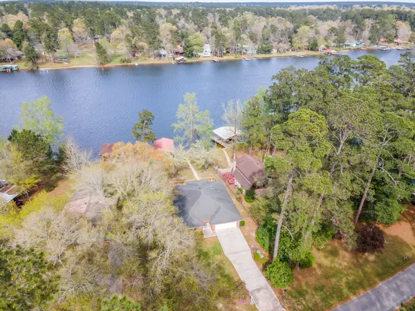 a view of a lake with a flower and a bench