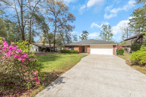 a view of a house with a yard and garden