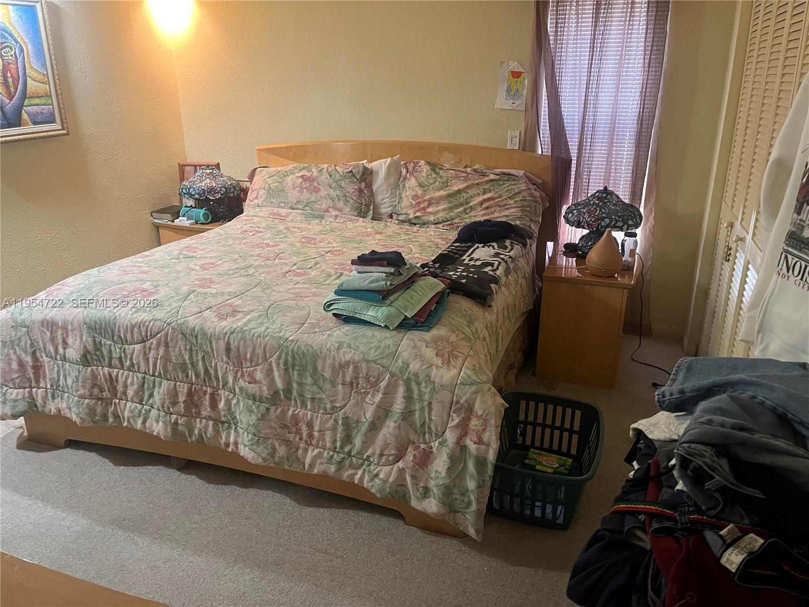 11041 Southwest 166th Terrace Miami, FL 33157 - Photo 16 of 26 a bed sitting in a bedroom next to a window