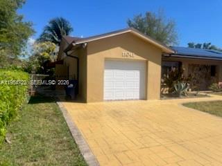 11041 Southwest 166th Terrace Miami, FL 33157 - Photo 5 of 26 a front view of a house with a yard