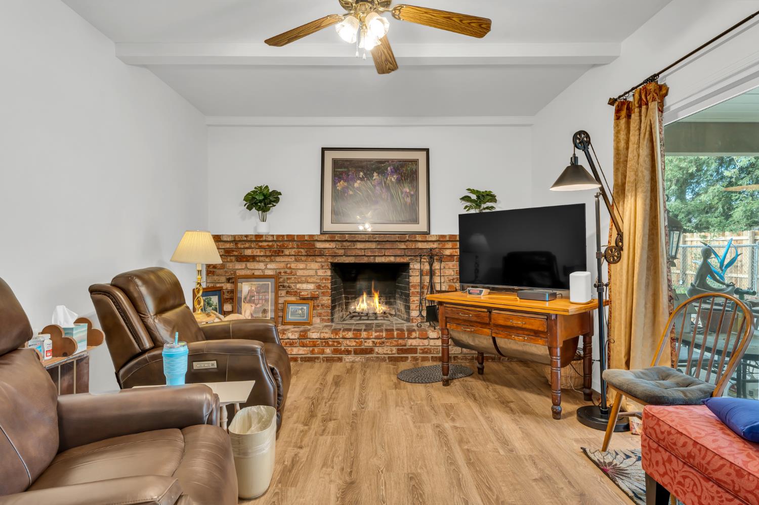 3307 Seaborg Way Sacramento, CA 95827 - Photo 19 of 45 a living room with furniture a flat screen tv and a fireplace
