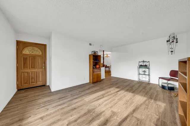 a bedroom with a bed and a refrigerator