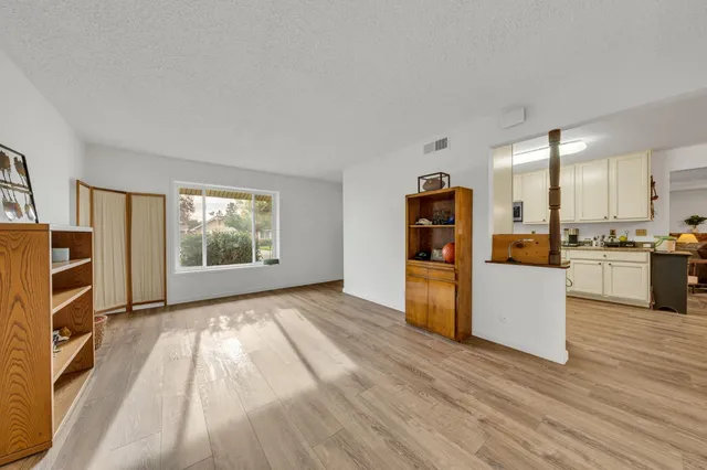 a view of kitchen with furniture and refrigerator