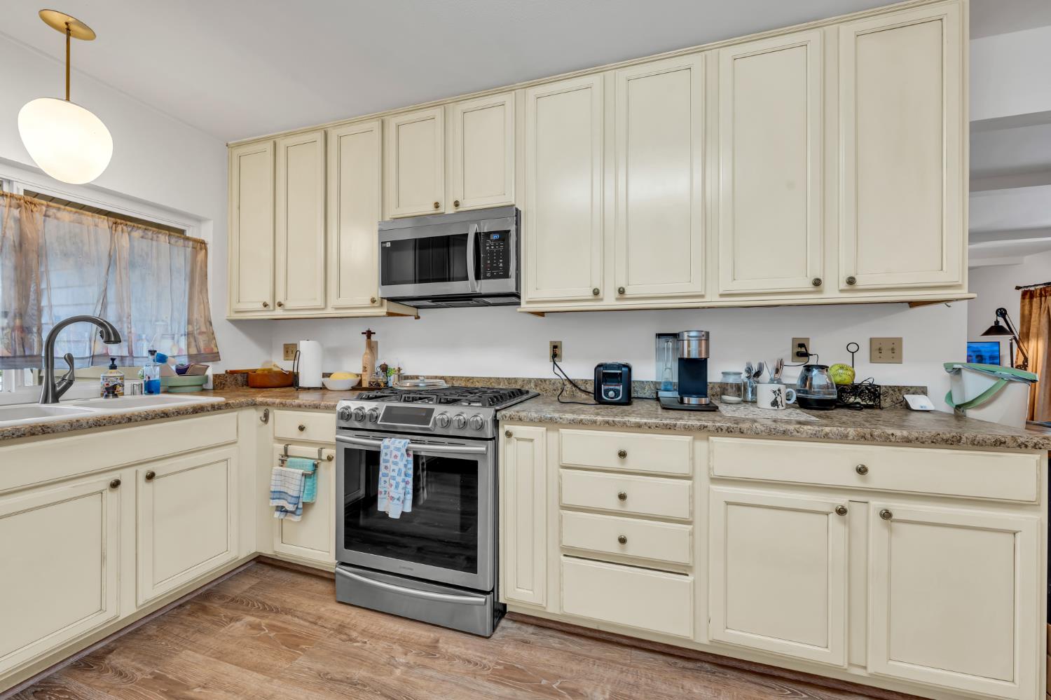 3307 Seaborg Way Sacramento, CA 95827 - Photo 10 of 45 a kitchen with granite countertop white cabinets and stainless steel appliances