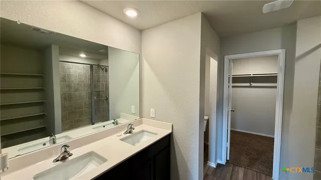 an empty room with a window and a ceiling fan