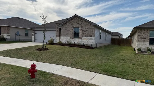 a front view of a house with a yard
