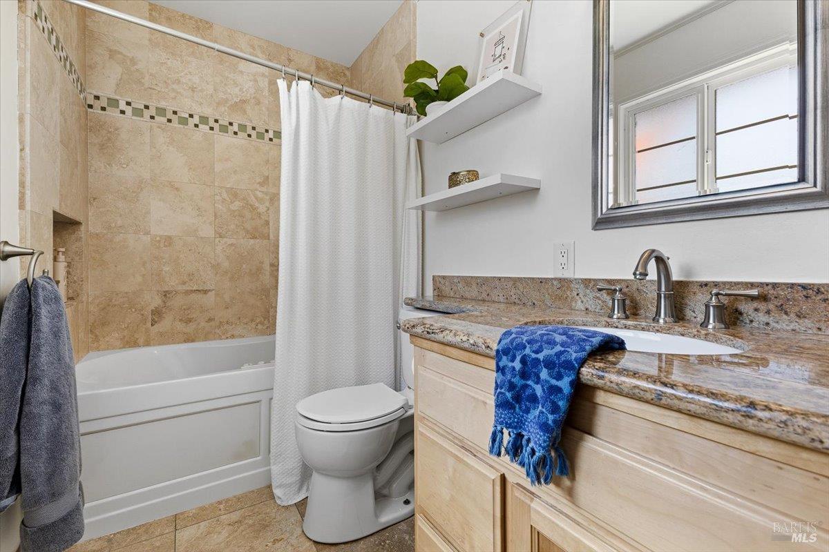 6900 Montecito Boulevard Santa Rosa, CA 95409 - Photo 16 of 25 a bathroom with a granite countertop sink a toilet and shower