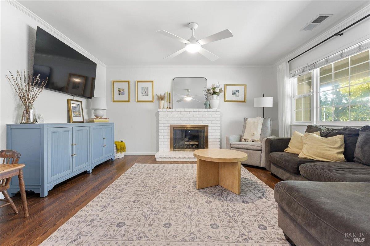 6900 Montecito Boulevard Santa Rosa, CA 95409 - Photo 5 of 25 a living room with furniture a flat screen tv and a fireplace