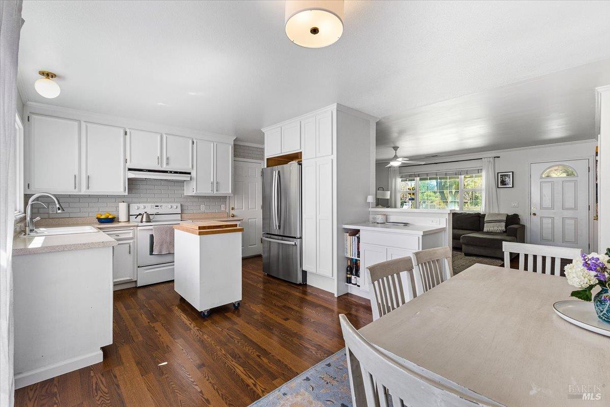 6900 Montecito Boulevard Santa Rosa, CA 95409 - Photo 7 of 25 a kitchen with sink a refrigerator and wooden floor