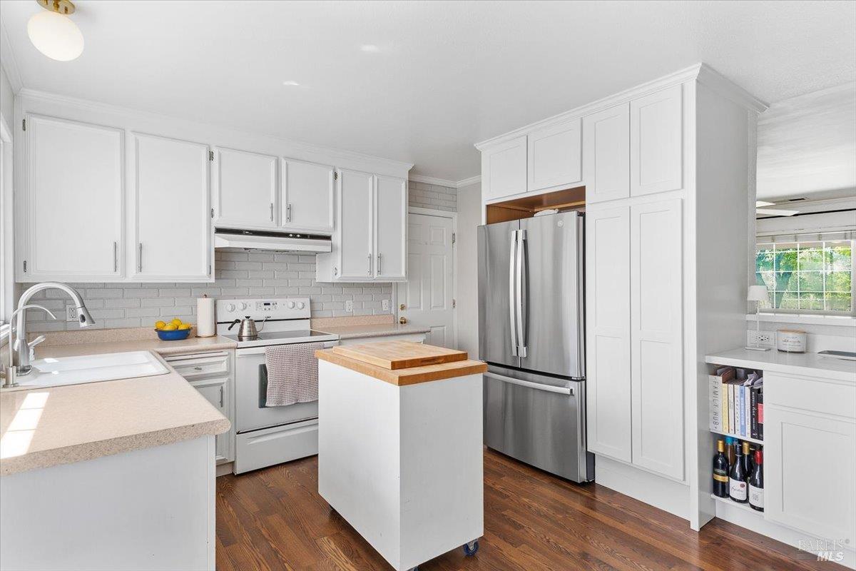 6900 Montecito Boulevard Santa Rosa, CA 95409 - Photo 8 of 25 a kitchen with stainless steel appliances a refrigerator sink and cabinets