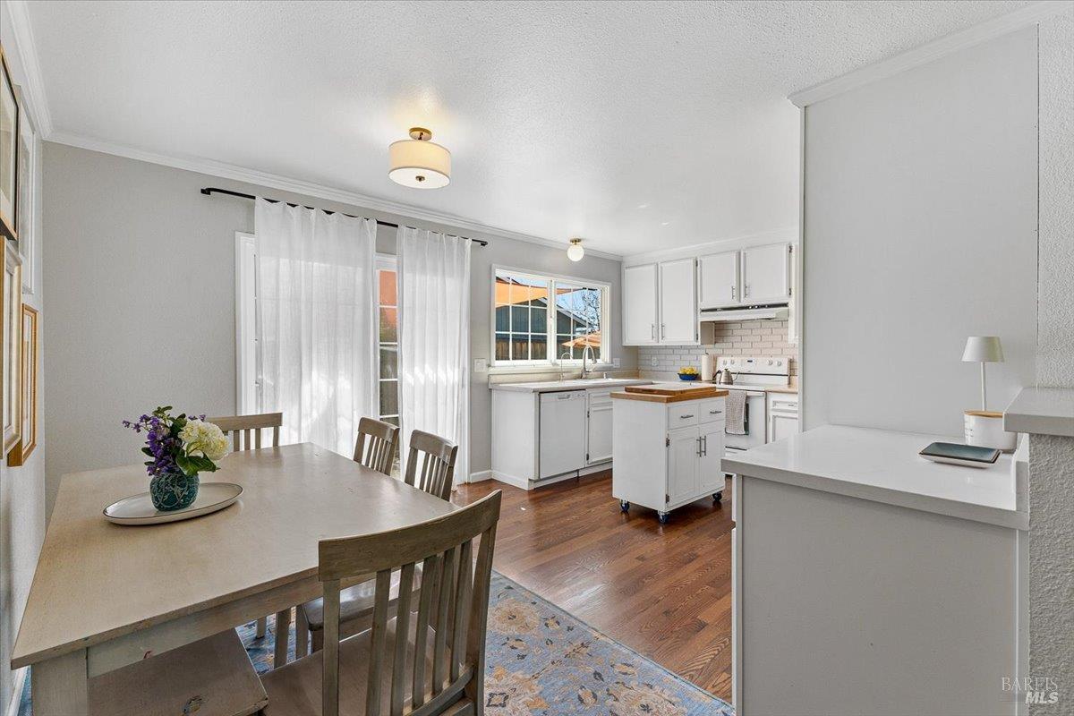 6900 Montecito Boulevard Santa Rosa, CA 95409 - Photo 9 of 25 a kitchen with a table chairs refrigerator and cabinets