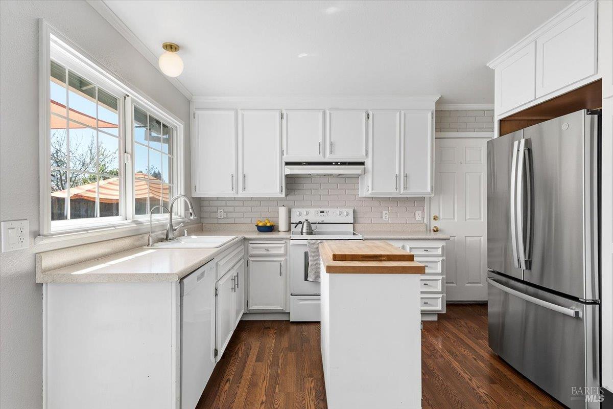6900 Montecito Boulevard Santa Rosa, CA 95409 - Photo 10 of 25 a kitchen with white cabinets and stainless steel appliances