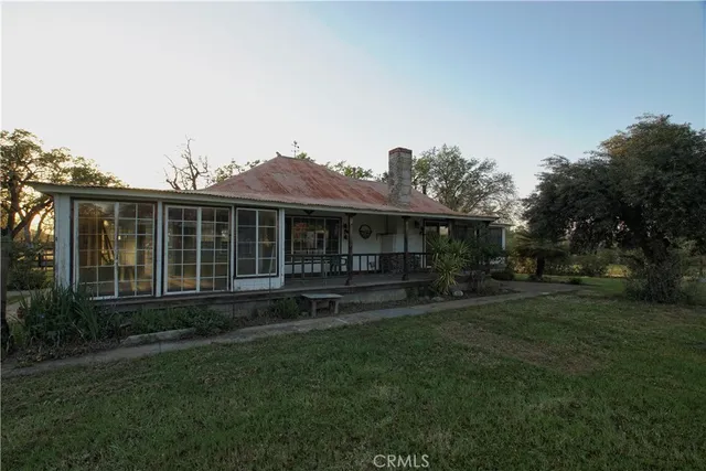 a view of a house with a yard and sitting area